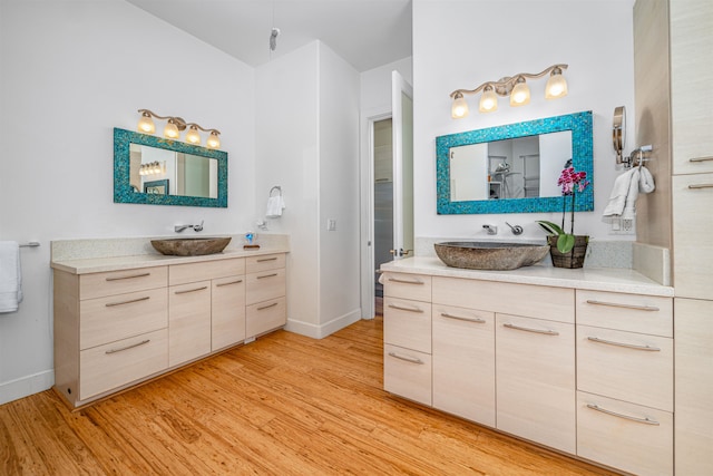 bathroom with hardwood / wood-style floors and vanity