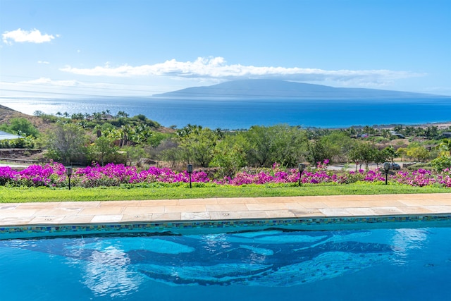 view of pool with a water and mountain view