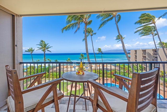 balcony with a beach view and a water view