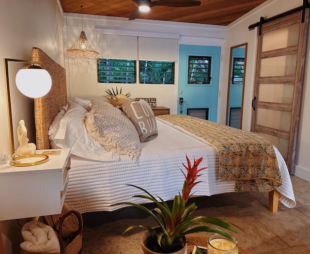 bedroom with wooden ceiling and a barn door