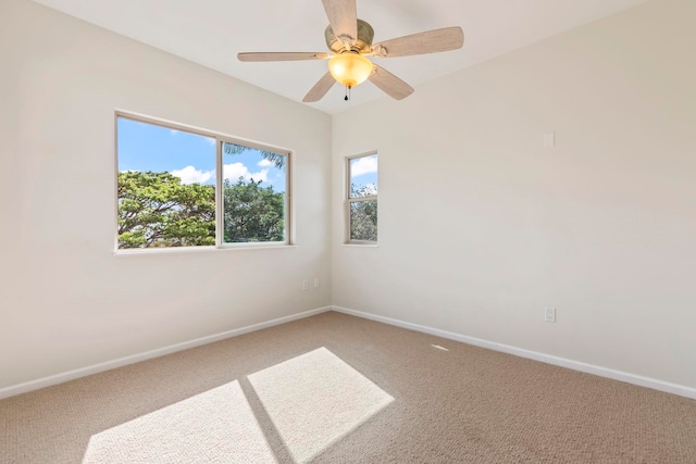 unfurnished room with light colored carpet, ceiling fan, and baseboards