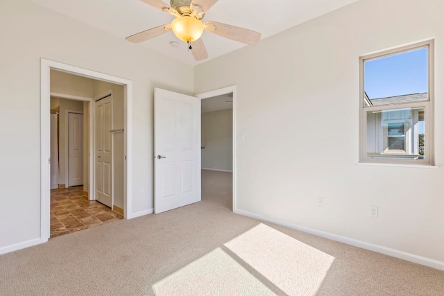unfurnished bedroom with ceiling fan, baseboards, and carpet floors