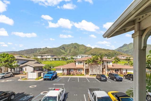 uncovered parking lot featuring a mountain view and a residential view