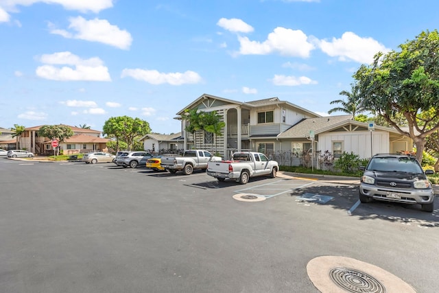 uncovered parking lot featuring a residential view