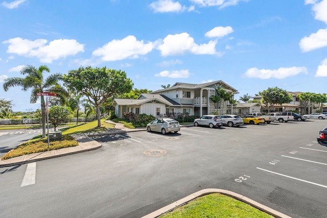 uncovered parking lot featuring a residential view