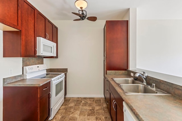 kitchen featuring a sink, ceiling fan, white appliances, baseboards, and dark brown cabinets