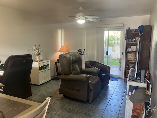 living area featuring tile patterned floors and ceiling fan