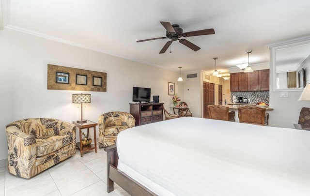 bedroom featuring light tile patterned flooring, crown molding, and ceiling fan