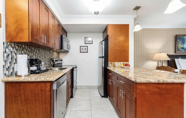 kitchen with light tile patterned flooring, decorative light fixtures, kitchen peninsula, stainless steel appliances, and light stone countertops