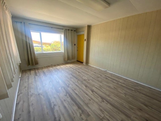 unfurnished room with wood finished floors