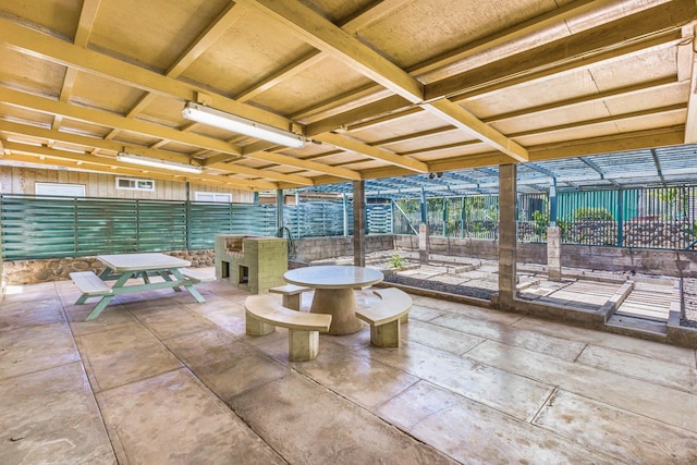 view of patio featuring fence and outdoor dining area