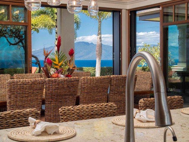 dining area with a water and mountain view and sink