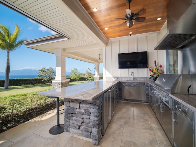 view of patio / terrace with ceiling fan, area for grilling, a mountain view, and sink