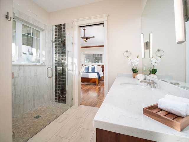 bathroom featuring walk in shower, vanity, hardwood / wood-style flooring, and plenty of natural light