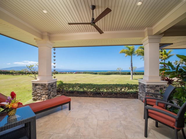 view of patio / terrace with ceiling fan and a mountain view