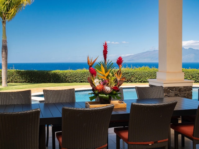 view of patio / terrace featuring a fenced in pool and a water view