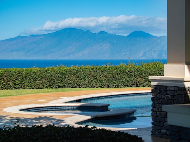 view of pool featuring a mountain view and a jacuzzi