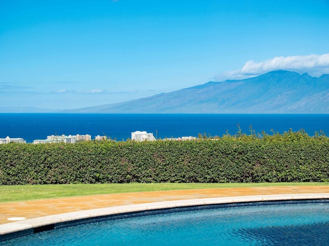 view of pool with a water and mountain view