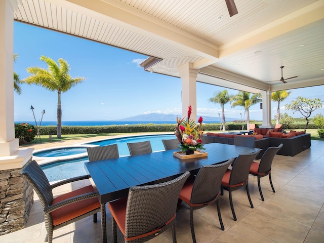 view of patio / terrace with ceiling fan, an outdoor living space, a swimming pool with hot tub, and a mountain view