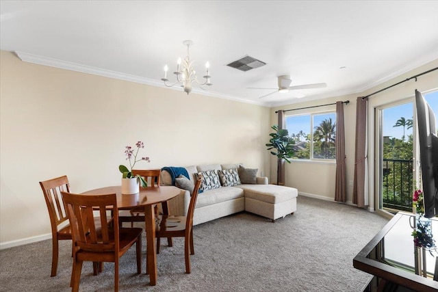 carpeted dining area with crown molding and ceiling fan with notable chandelier