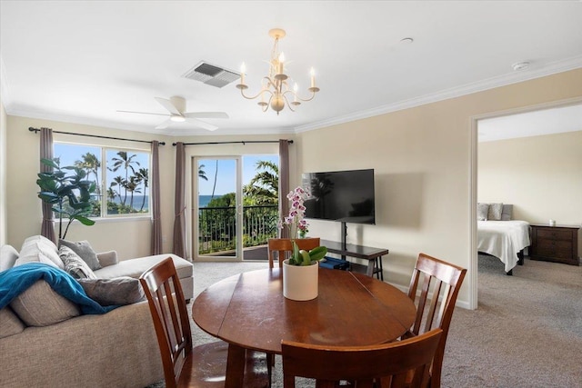 carpeted dining area featuring crown molding and ceiling fan with notable chandelier