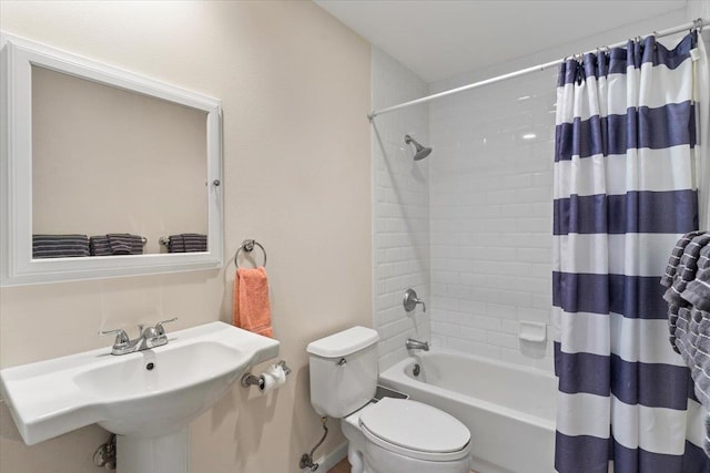 full bathroom with sink, shower / tub combo with curtain, and toilet