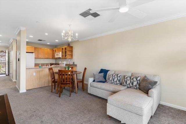 carpeted living room with ornamental molding and ceiling fan with notable chandelier