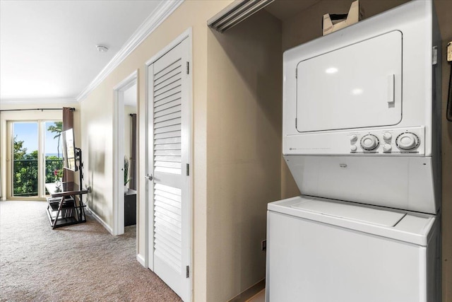 laundry area featuring crown molding, stacked washer / dryer, and carpet