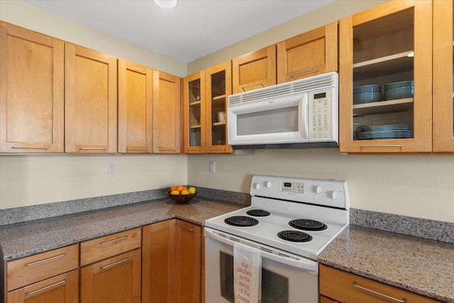 kitchen featuring white appliances and stone counters