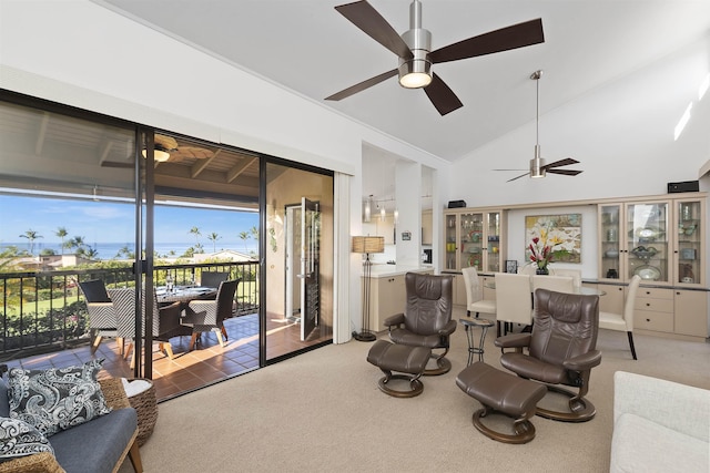 sitting room featuring carpet floors, lofted ceiling, and a ceiling fan