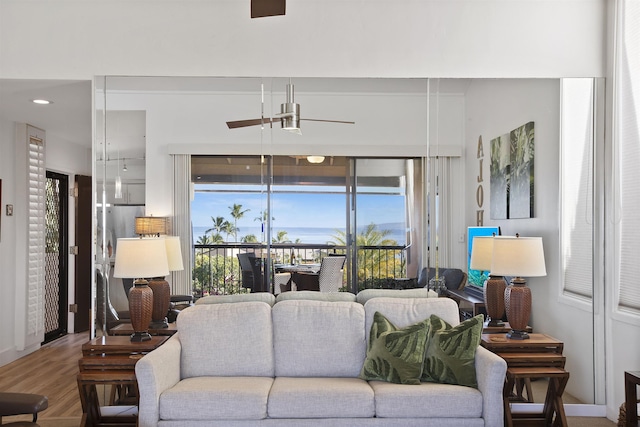 living room with ceiling fan and wood finished floors