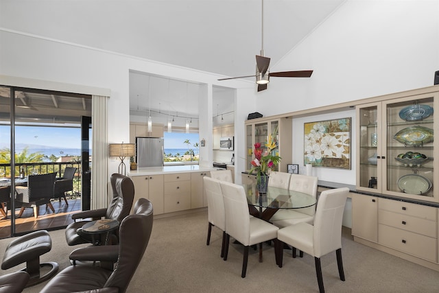 dining room featuring light carpet, rail lighting, and ceiling fan