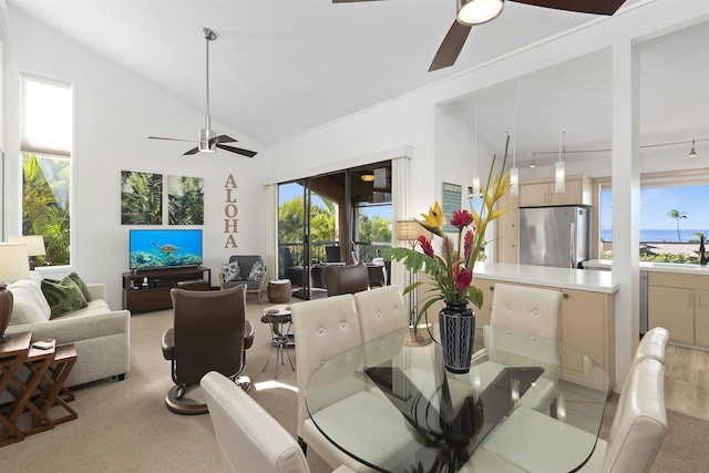 dining room with lofted ceiling, ceiling fan, and a healthy amount of sunlight