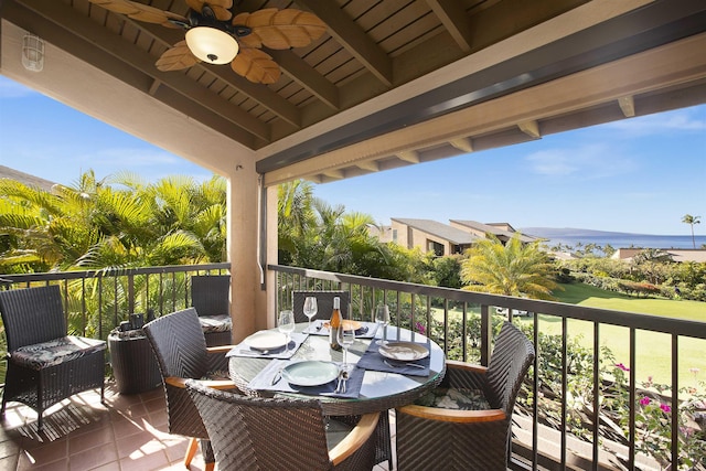 balcony with outdoor dining area and a ceiling fan