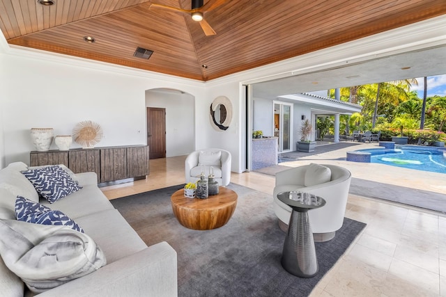 living room with ceiling fan, light tile patterned floors, and wooden ceiling