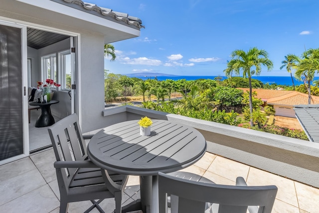 balcony with a water view and a patio area