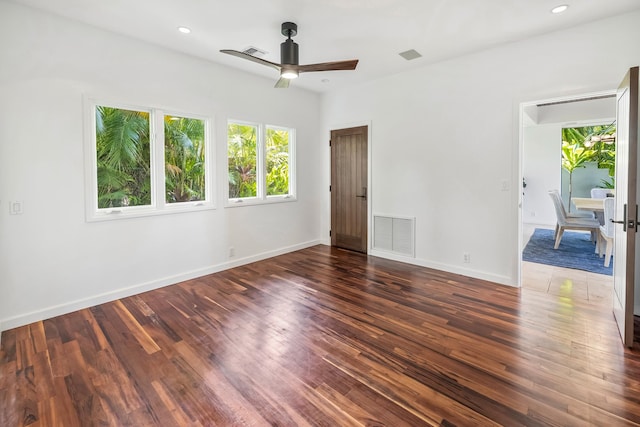 spare room with ceiling fan and dark hardwood / wood-style flooring