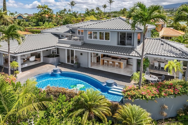 back of house with a patio and an outdoor living space