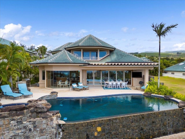 rear view of house featuring a patio area