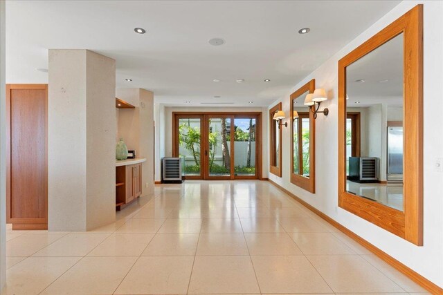 hall with light tile patterned flooring