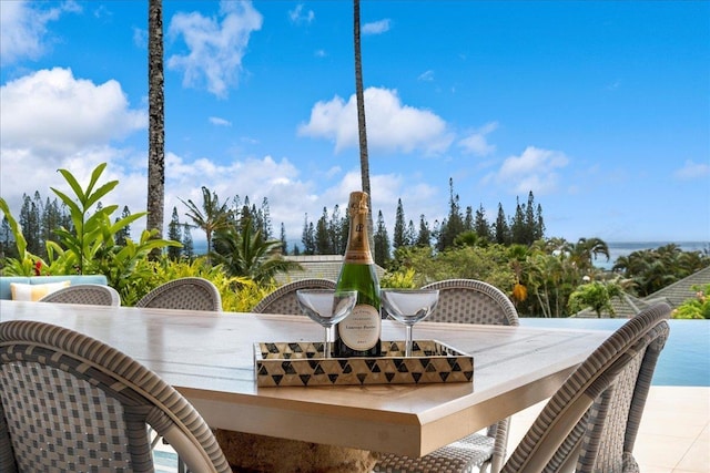 view of patio featuring a water view and an outdoor bar