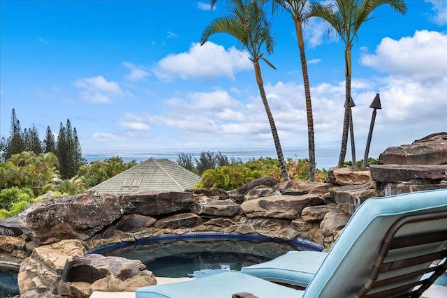 view of pool featuring a water view