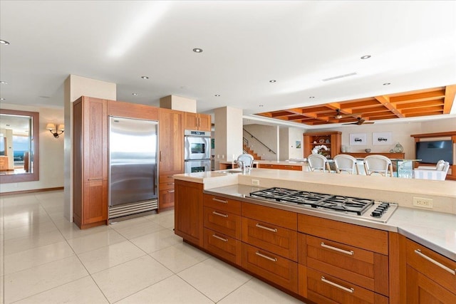 kitchen with light tile patterned floors and stainless steel appliances