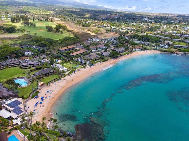 bird's eye view with a water view and a beach view