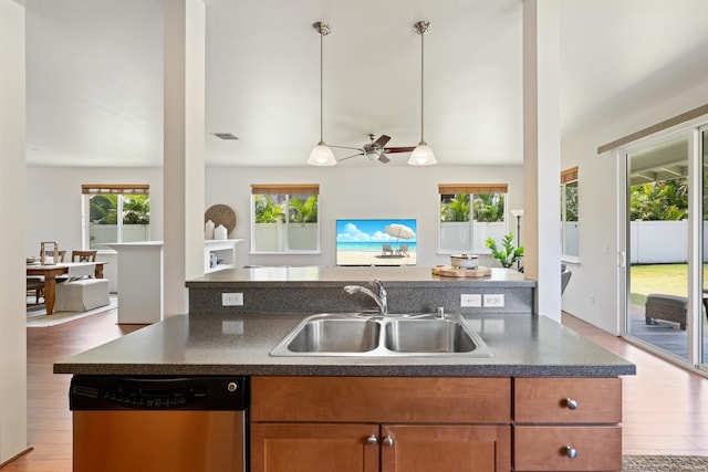 124 Kapela Pl, Kahului, HI 96732 - kitchen featuring dishwasher, a sink, open floor plan, wood finished floors, and dark countertops