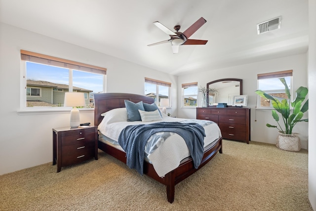 124 Kapela Pl, Kahului, HI 96732 - bedroom with light colored carpet, multiple windows, visible vents, and a ceiling fan
