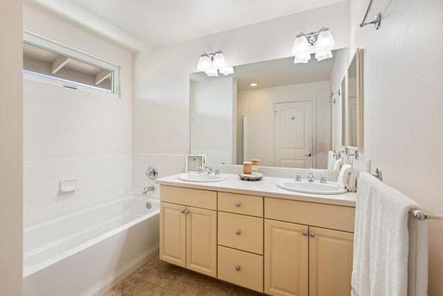 124 Kapela Pl, Kahului, HI 96732 - bathroom featuring a bath, tile patterned flooring, double vanity, and a sink