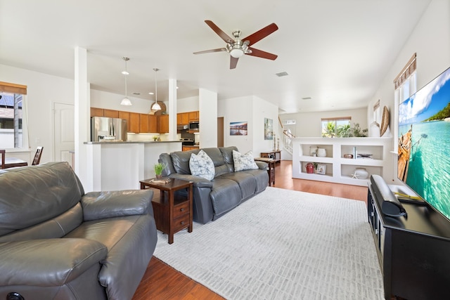 124 Kapela Pl, Kahului, HI 96732 - living area featuring a ceiling fan, a healthy amount of sunlight, and wood finished floors