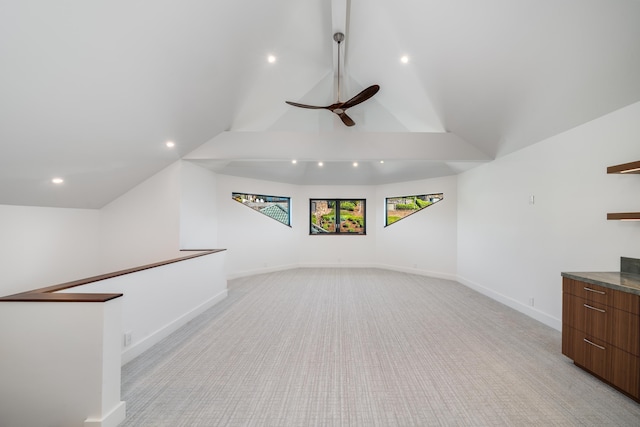 unfurnished living room featuring lofted ceiling, light colored carpet, and ceiling fan