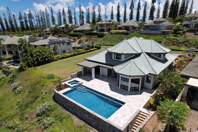 view of swimming pool featuring a sunroom and a patio area